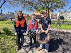 Image of students hold trash they cleaned up