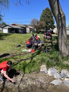 Image of students and staff cleaning up